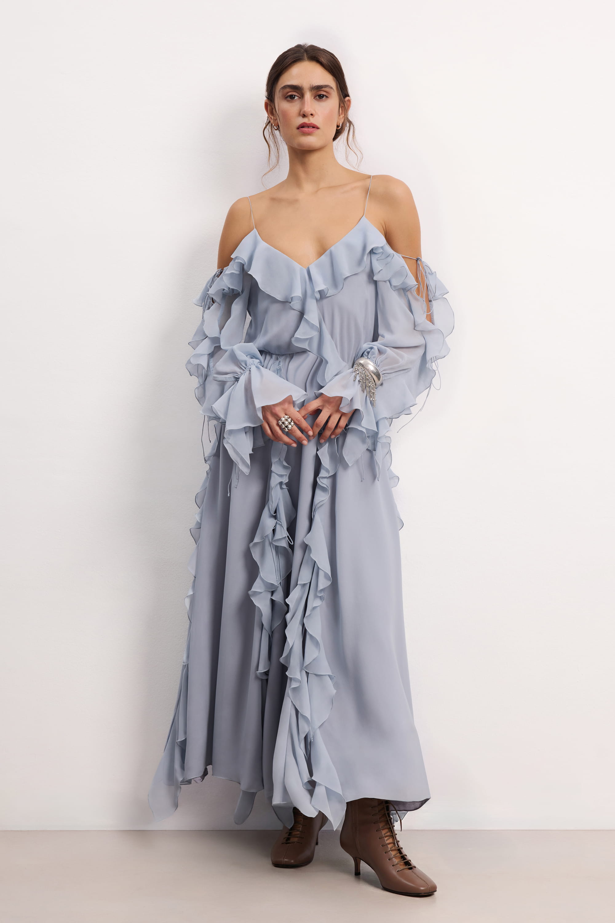 Woman wearing a blue fog off-shoulder ruffled Morning Forest midi dress on a white background, front view