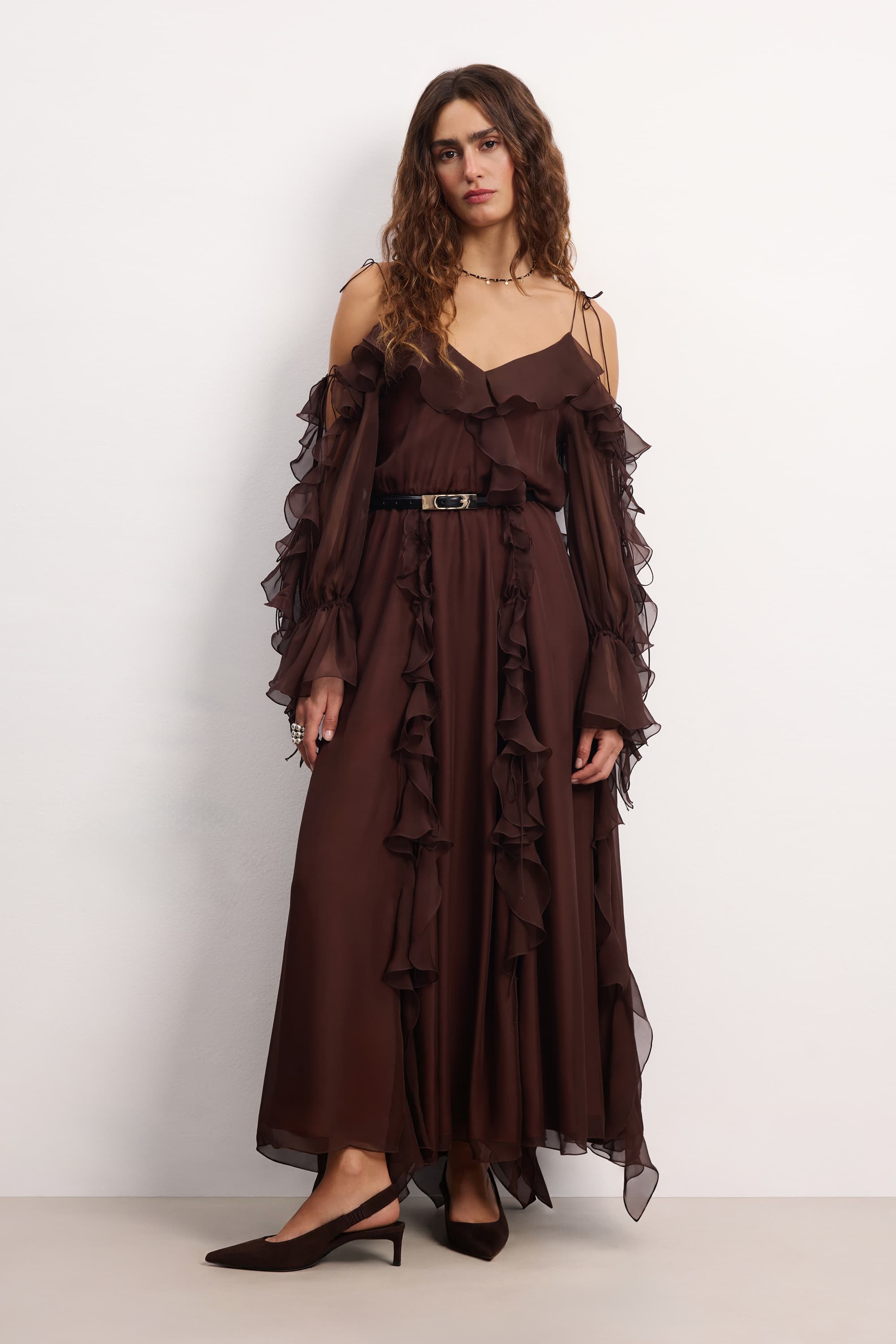 Woman wearing a brown off-shoulder ruffled Morning Forest midi dress on a white background, front view