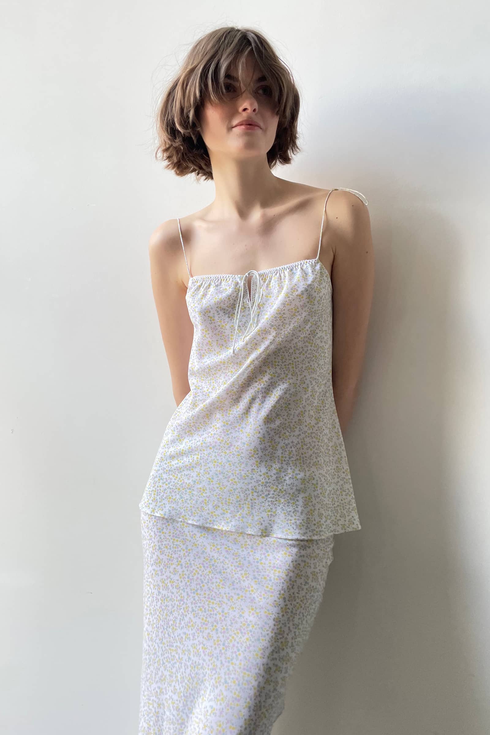 Model in tie shoulder top set with a bias cut midi skirt