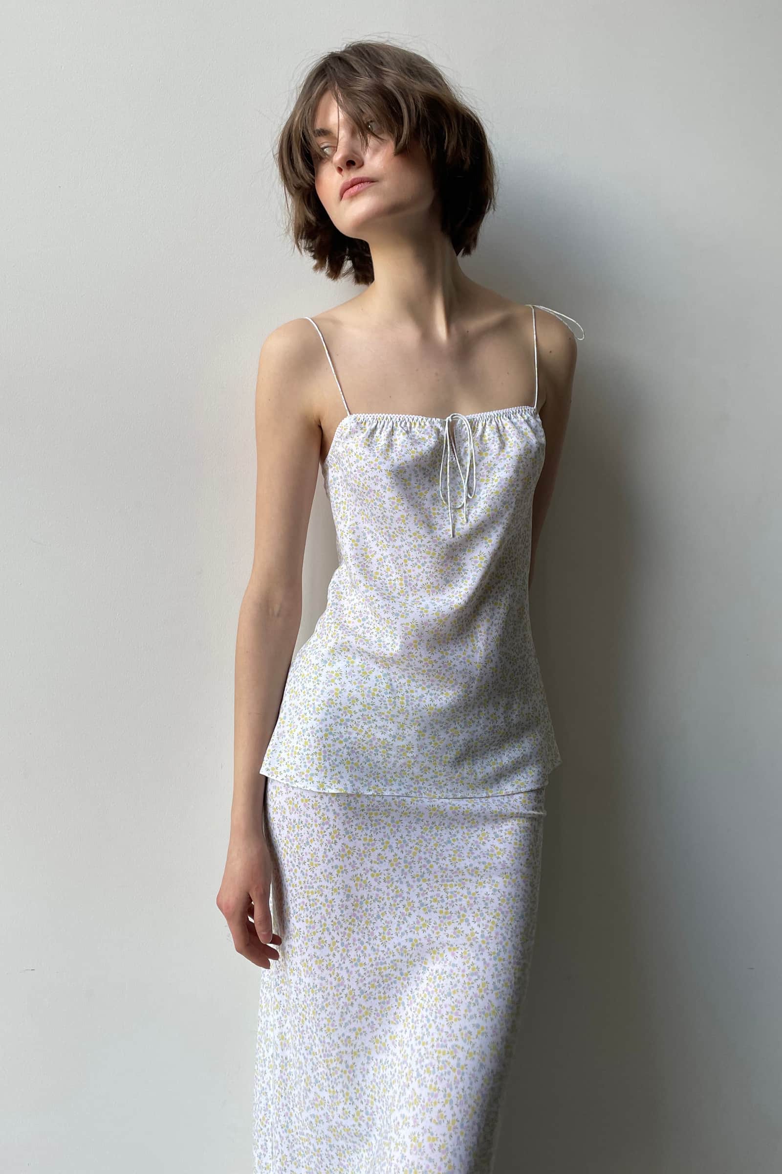 Model in tie shoulder top set with a bias cut midi skirt