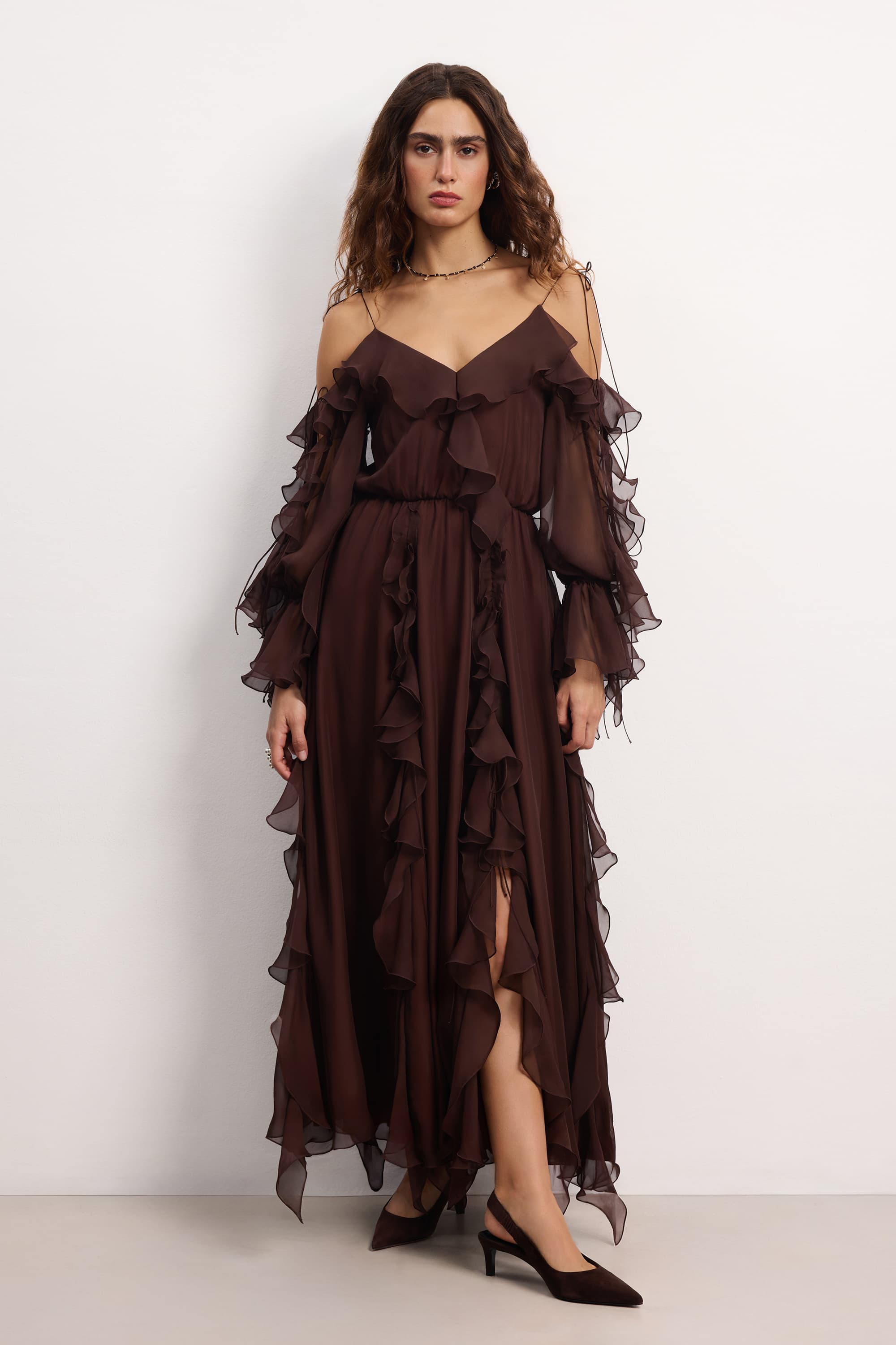 Woman wearing a brown off-shoulder ruffled Morning Forest midi dress on a white background, front view